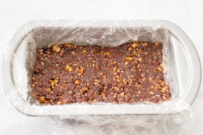 Raw date brownies packed in a pan