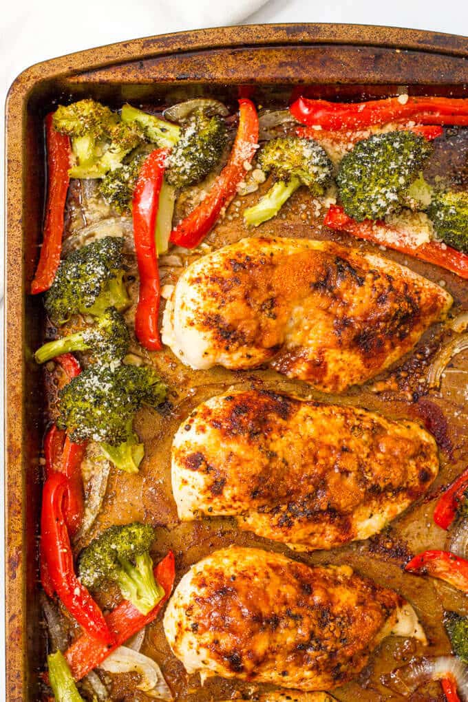 Parmesan sheet pan chicken and broccoli with bell peppers makes for an easy, hands-off healthy dinner! | www.familyfoodonthetable.com