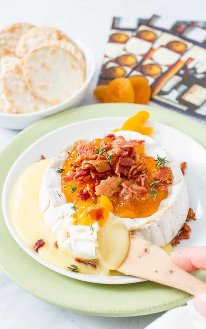 Easy microwave baked brie with apricots, thyme and bacon is a super fast way to make a delicious, impressive appetizer! | www.familyfoodonthetable.com