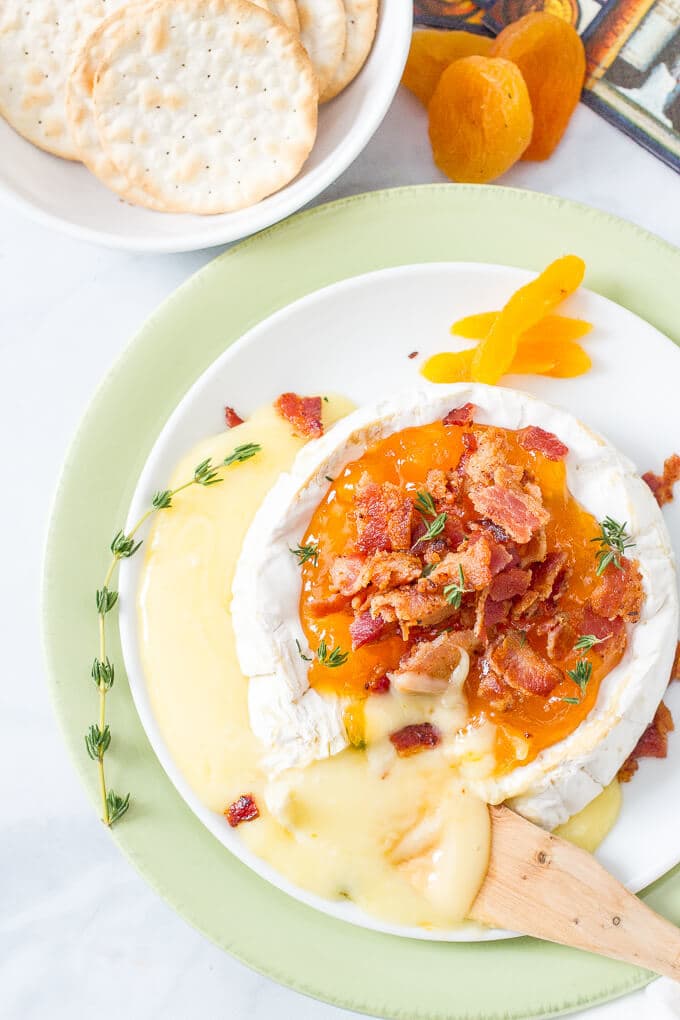 Easy microwave baked brie with apricots, thyme and bacon is a super fast way to make a delicious, impressive appetizer! | www.familyfoodonthetable.com