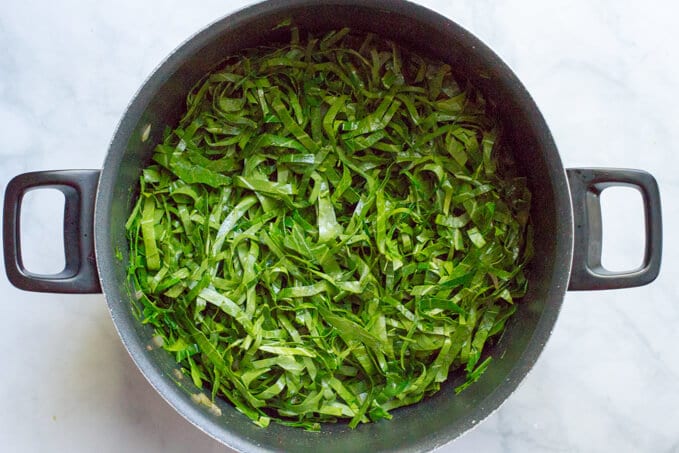 Sliced collard greens in a pot