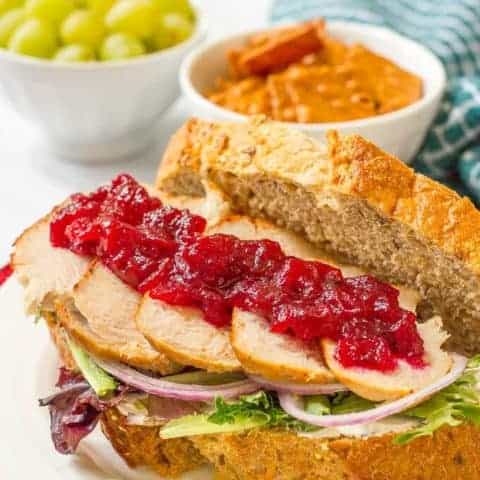 Leftover Thanksgiving turkey sandwiches with cream cheese, cranberry sauce, greens and red onion - a delicious easy lunch! | www.familyfoodonthetable.com