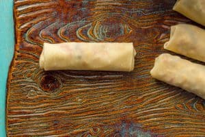 A wrapped wonton before being cooked into an egg roll
