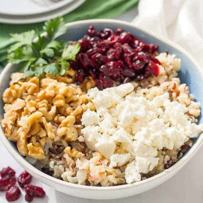 Warm wild rice salad with cranberries, pecans and goat cheese is a delicious combination of flavors and textures - perfect for a holiday side dish! | www.familyfoodonthetable.com