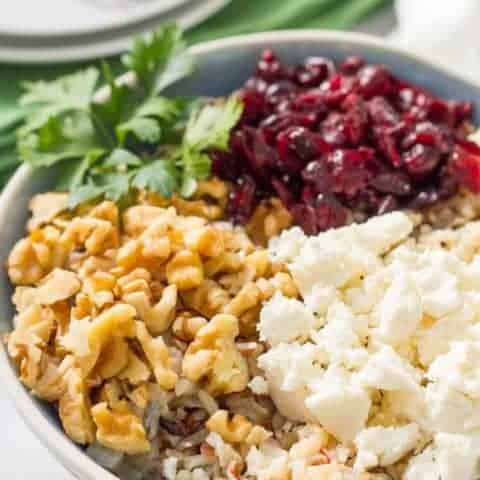 Warm wild rice salad with cranberries, pecans and goat cheese is a delicious combination of flavors and textures - perfect for a holiday side dish! | www.familyfoodonthetable.com