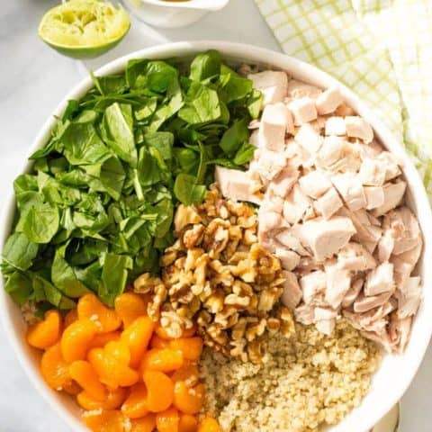 Quinoa chicken spinach salad with mandarin oranges, walnuts and a honey-lime vinaigrette -- a flavorful main dish salad that’s ready in just 20 minutes! | www.familyfoodonthetable.com