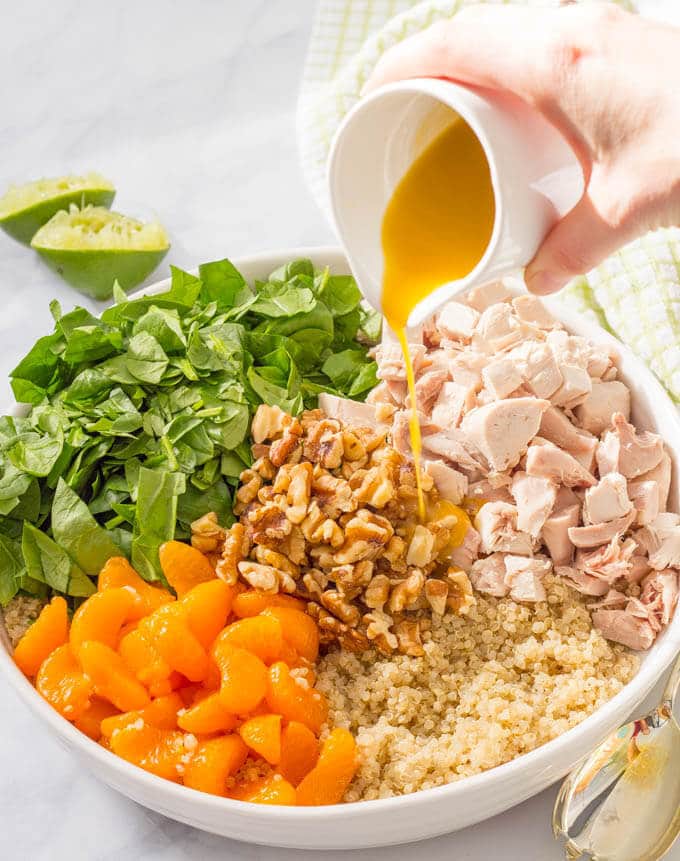 Quinoa chicken spinach salad with mandarin oranges, walnuts and a honey-lime vinaigrette -- a flavorful main dish salad that’s ready in just 20 minutes! | www.familyfoodonthetable.com