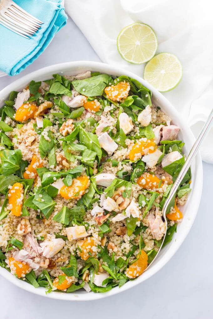 Quinoa chicken spinach salad with mandarin oranges, walnuts and a honey-lime vinaigrette -- a flavorful main dish salad that’s ready in just 20 minutes! | www.familyfoodonthetable.com