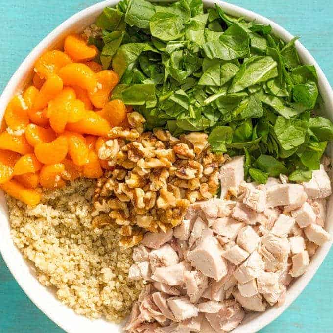 Quinoa chicken spinach salad with mandarin oranges, walnuts and a honey-lime vinaigrette -- a flavorful main dish salad that’s ready in just 20 minutes! | www.familyfoodonthetable.com