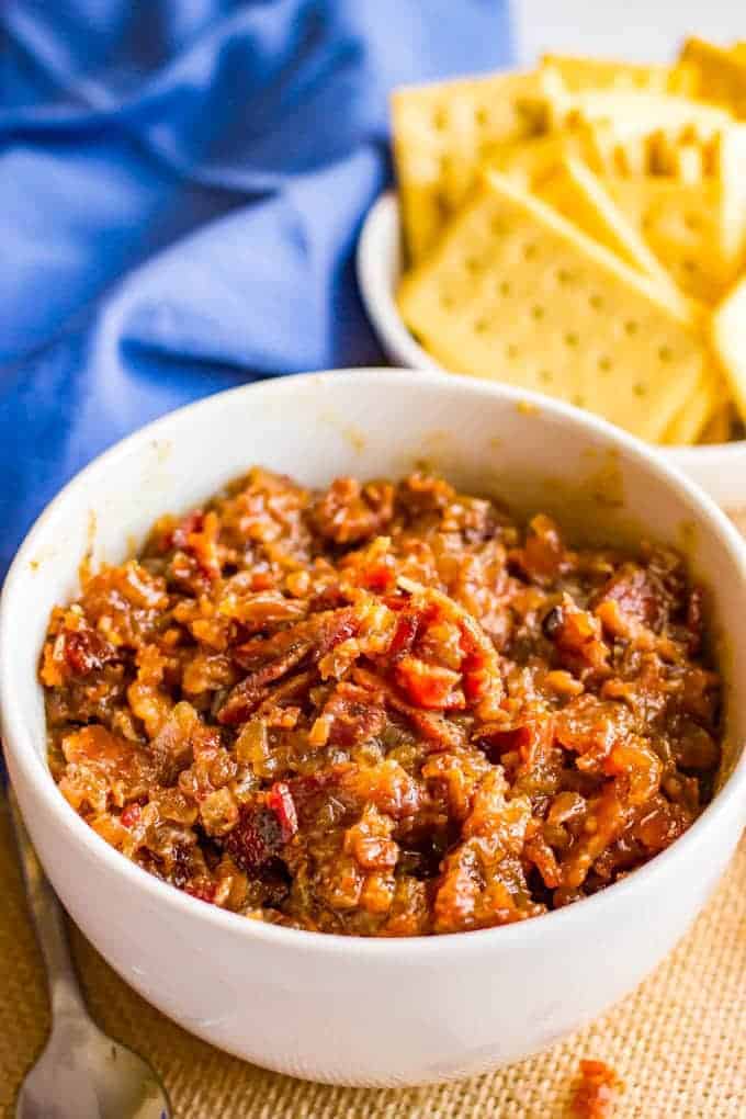 A bowl of bourbon bacon jam with a bowl of crackers in the background