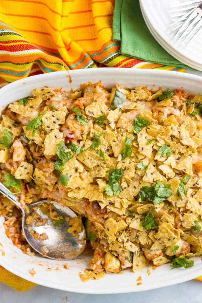 Healthy chicken taco casserole with brown rice is an easy weeknight dinner with a cheese and crunchy tortilla chip topping! | www.familyfoodonthetable.com