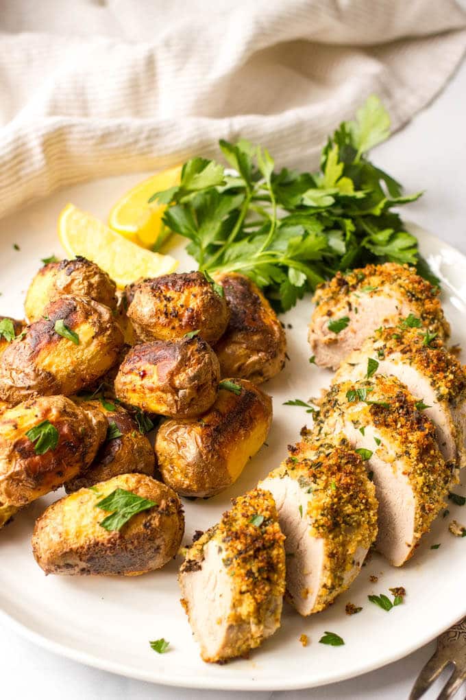 Herb roasted pork tenderloin with potatoes is an easy but elegant sheet pan dinner with tons of flavor! | www.familyfoodonthetable.com