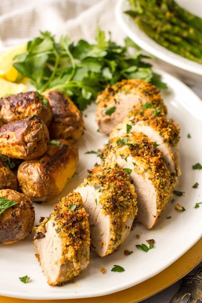 Herb roasted pork tenderloin with potatoes is an easy but elegant sheet pan dinner with tons of flavor! Great for company or a special occasion!