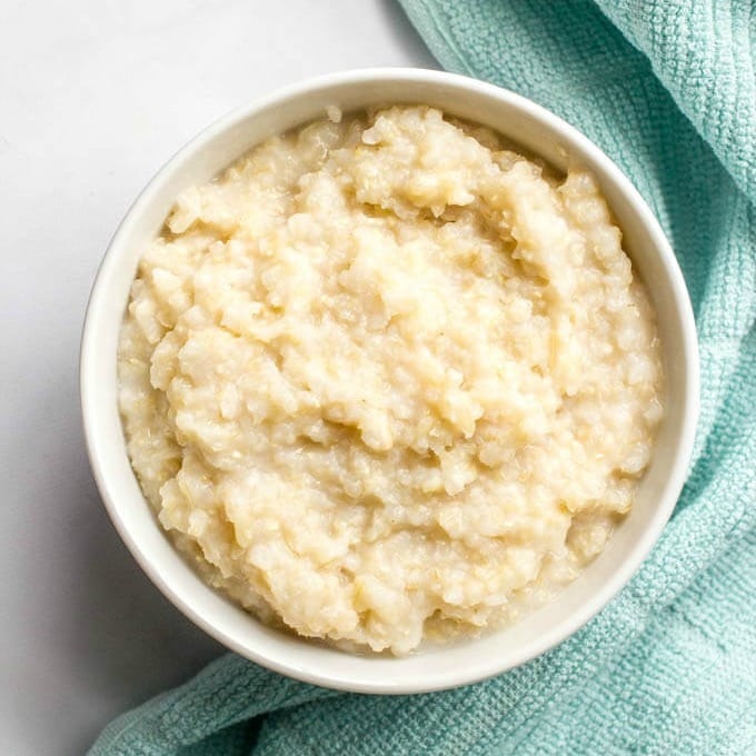 Pureed brown rice in a small white bowl.