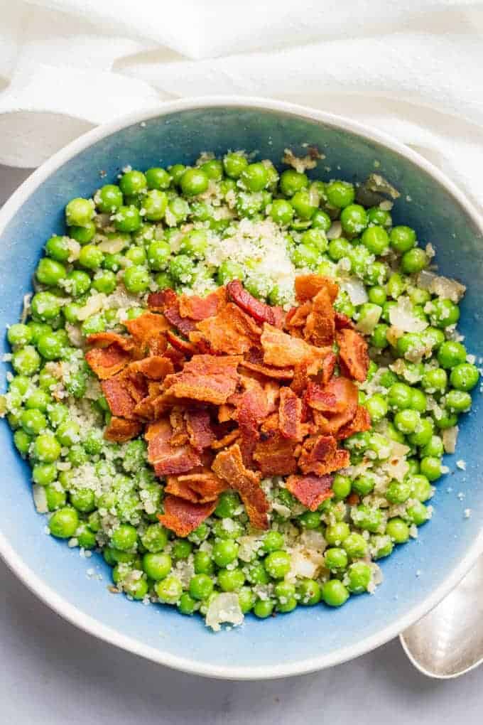 Peas with bacon, shallots and Parmesan cheese is a quick and easy side dish and super flavorful way to dress up a bag of frozen peas! | www.familyfoodonthetable.com