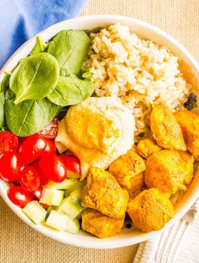 Turmeric chicken bowls with basmati rice, veggies and hummus are a quick, easy and super flavorful dinner!