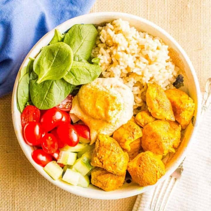 Turmeric chicken bowls with basmati rice, veggies and hummus are a quick, easy and super flavorful dinner!