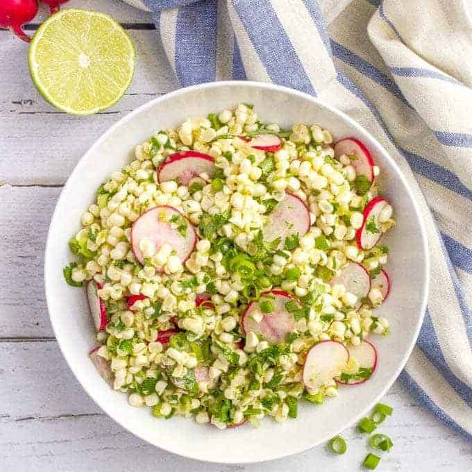Quick + easy spicy corn radish salad with cilantro and a zesty lime vinaigrette-- perfect as a healthy spring or summer side! | www.familyfoodonthetable.com