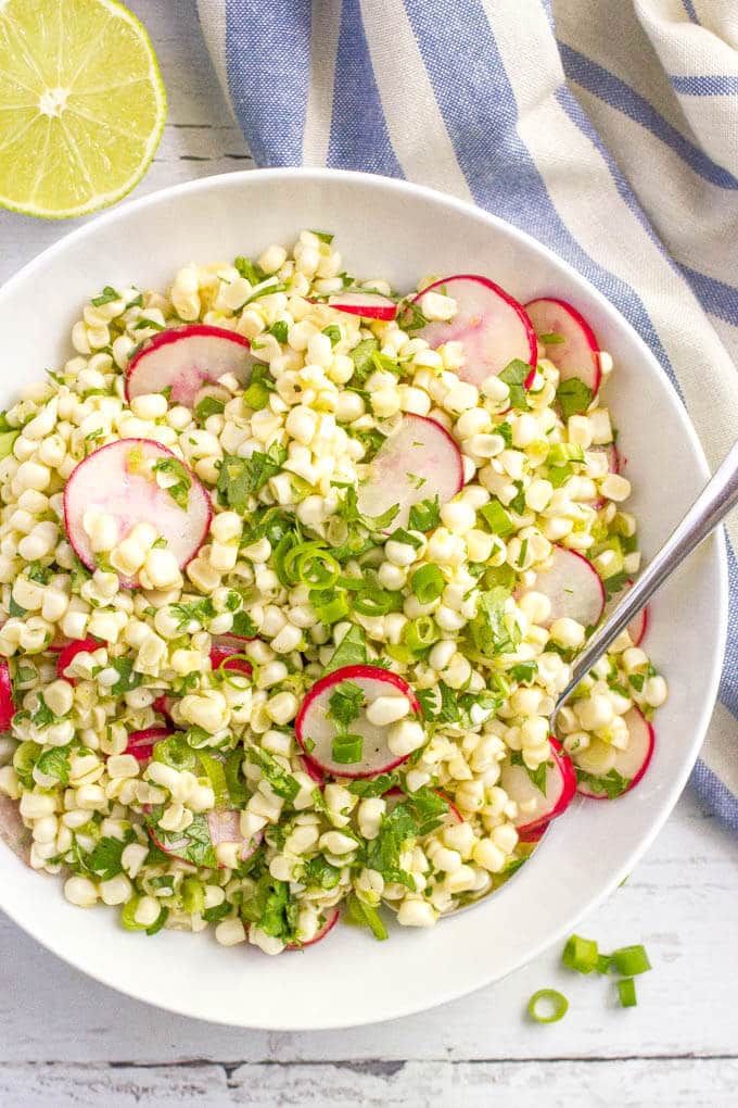 Quick + easy spicy corn radish salad with cilantro and a zesty lime vinaigrette -- perfect as a healthy spring or summer side! | www.familyfoodonthetable.com