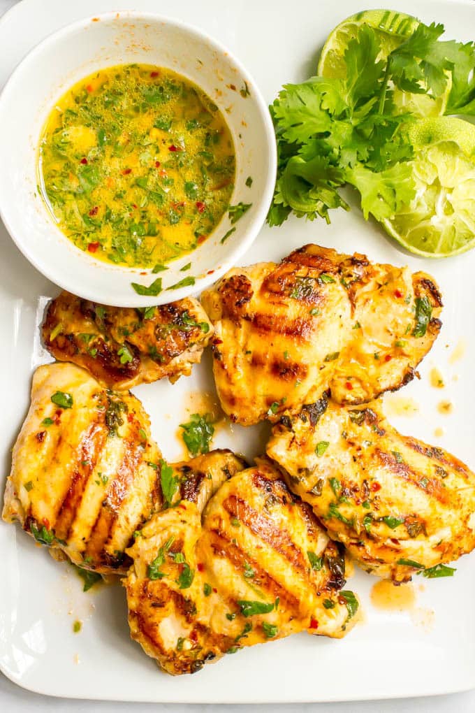Grilled chicken marinaded in a coconut lime marinade and served on a white platter