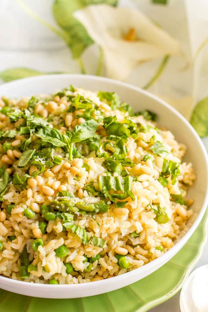 One-pot spring rice pilaf with asparagus and peas is a bright, fresh and easy side dish that’s topped with Parmesan cheese, fresh basil and (optional) pine nuts! #springrecipes #ricepilaf #brownrice #asparagus #sidedishes