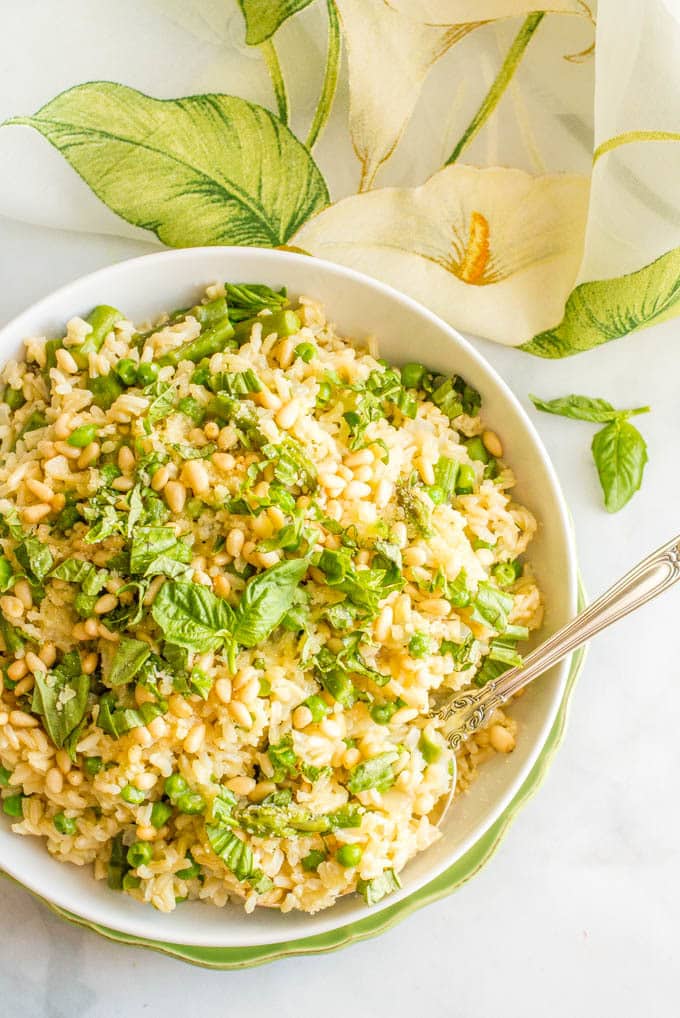 One-pot spring rice pilaf with asparagus and peas is a bright, fresh and easy side dish that’s topped with Parmesan cheese, fresh basil and (optional) pine nuts! | www.familyfoodonthetable.com