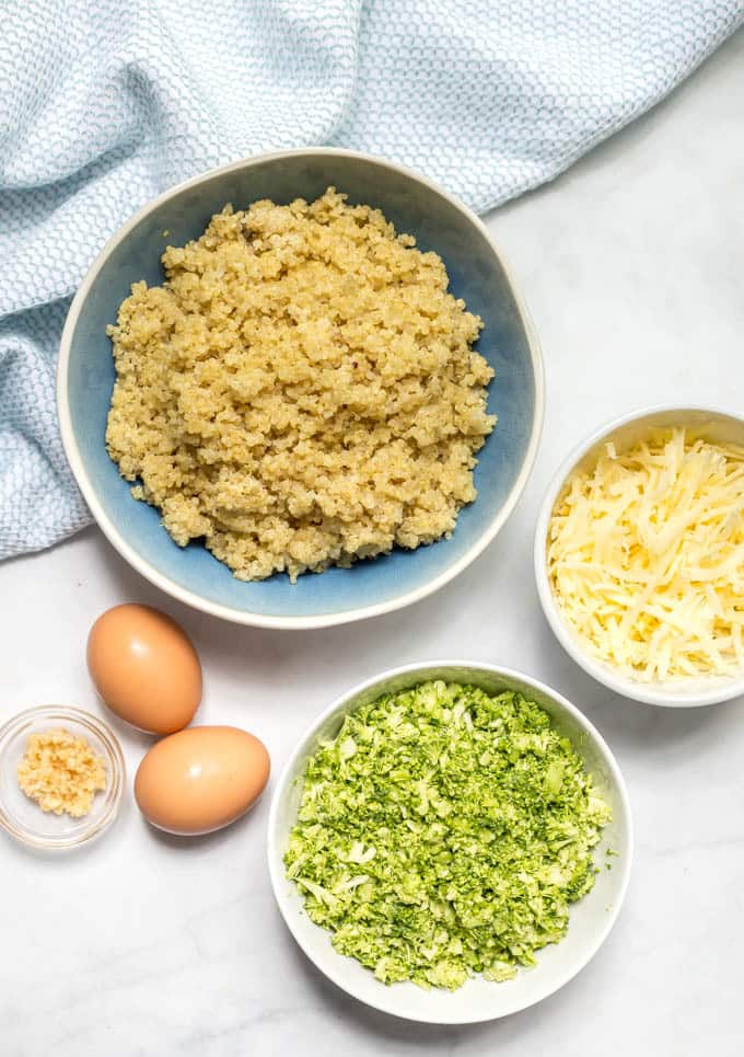 Broccoli cheese quinoa bites ingredients arranged in separate bowls.