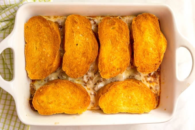 Cheesy sloppy Joe casserole after baking with crusty, golden brown bread