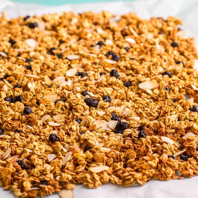Citrus granola baked and cooling on parchment paper