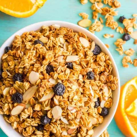 Healthy citrus granola bowl overhead with orange slices