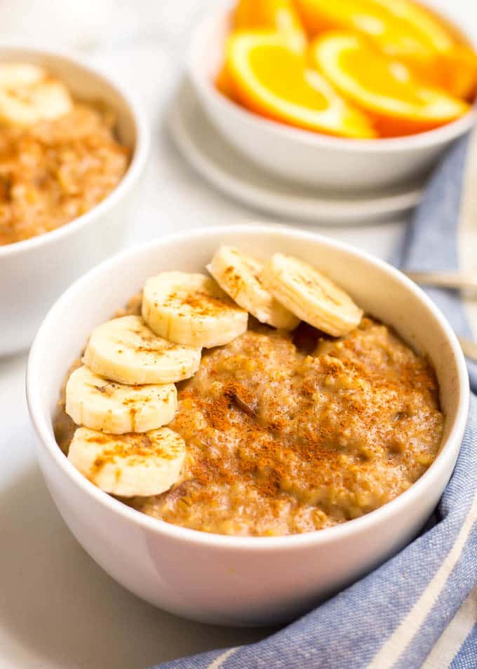 Slow cooker maple cinnamon oatmeal in a bowl with sliced bananas