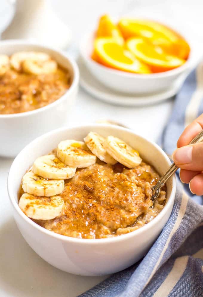 Slow cooker maple cinnamon oatmeal is perfect for busy mornings! Take a few minutes to prep the night before and a creamy, rich, flavorful oatmeal is waiting for you in the morning! | www.familyfoodonthetable.com