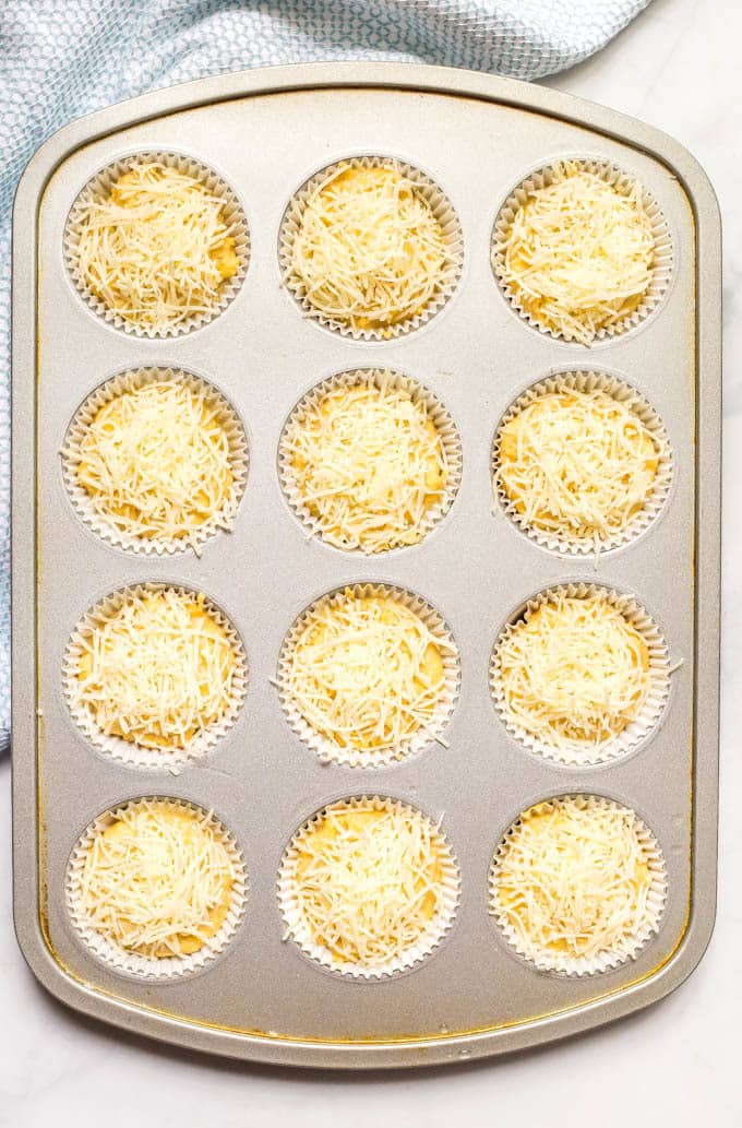 Overhead shot of easy cheesy cornbread muffins in muffin tin before baking