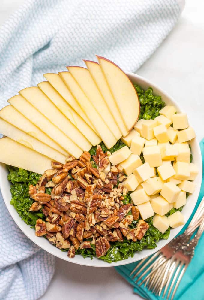 Kale apple salad with cheddar and pecans overhead arranged in bowl