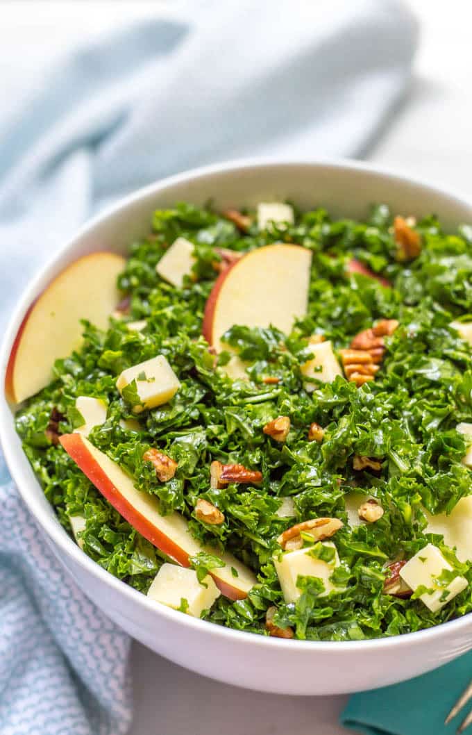 Kale apple salad with cheddar and pecans side angle close up