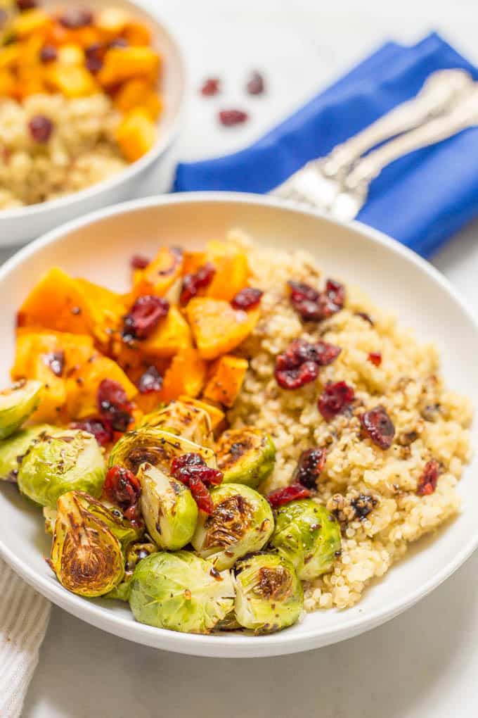 Quinoa bowl with butternut squash and Brussels sprouts close-up photo served in a bowl