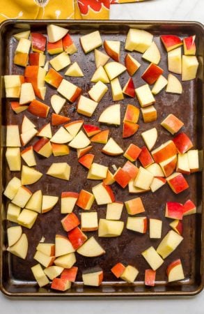 Cubed chunks of apple on roasting pan