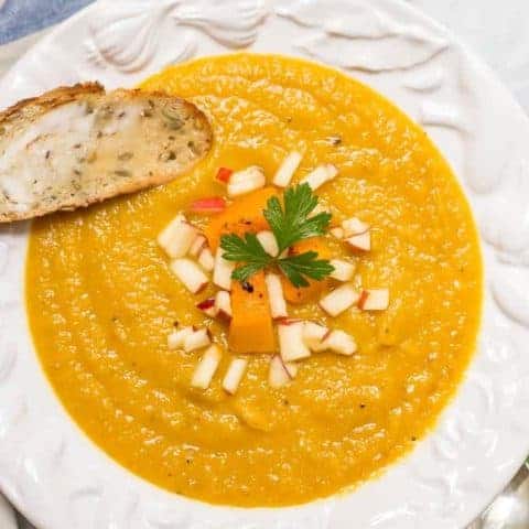 Roasted butternut squash apple soup is perfect for a cozy fall dinner! This soup is thick and filling and has a perfect background of sweetness and warm spices! | www.familyfoodonthetable.com