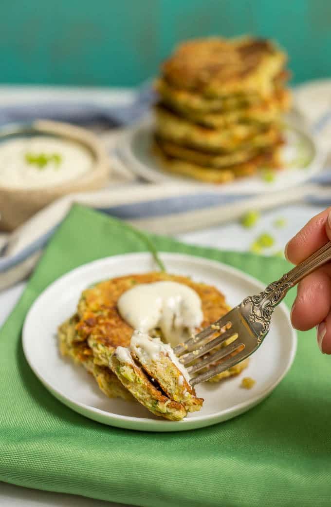 Whole wheat veggie pancakes with Ranch dressing and a forkful being taken out