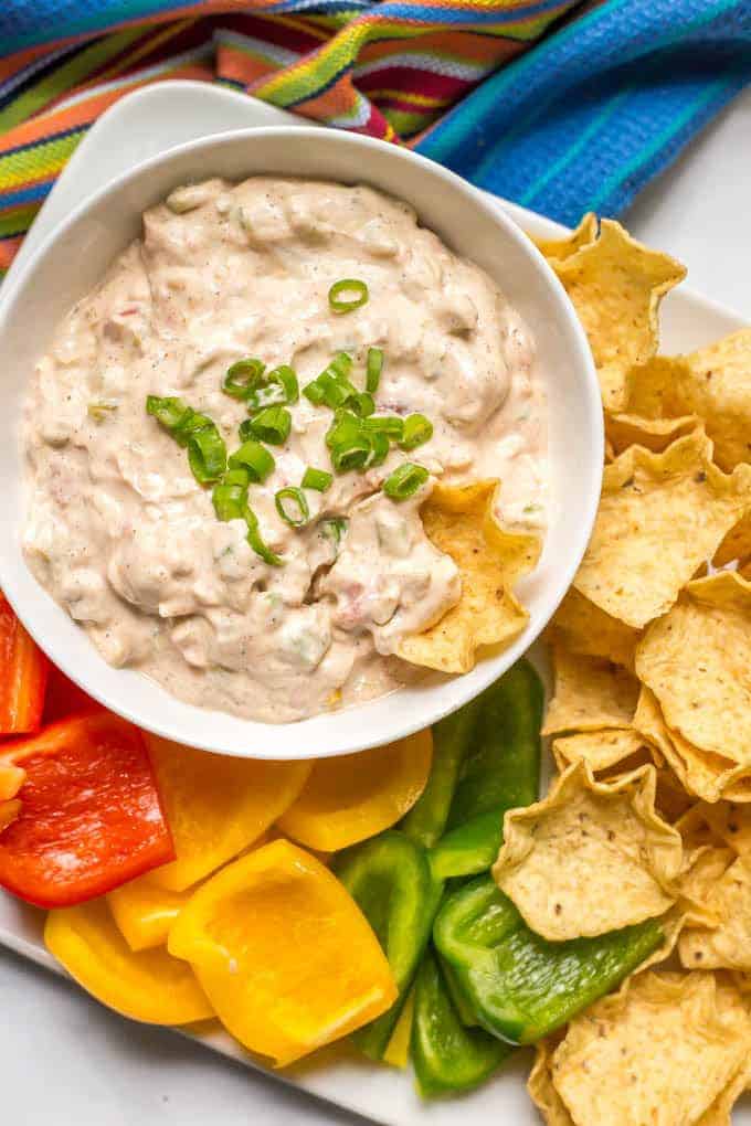 This cold chili cheese dip takes minutes to mix together and is delicious served with chips and veggies for an easy party or tailgating snack! It's also gluten-free and vegetarian. | www.familyfoodonthetable.com