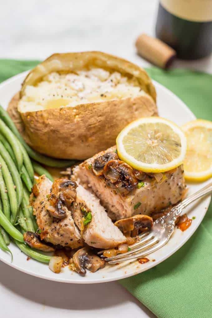 Garlic butter pork chops are an easy one-pan dish with a delicious mushroom-onion mixture and a hint of lemon to brighten all the flavors. Perfect for a weeknight family dinner! | www.familyfoodonthetable.com
