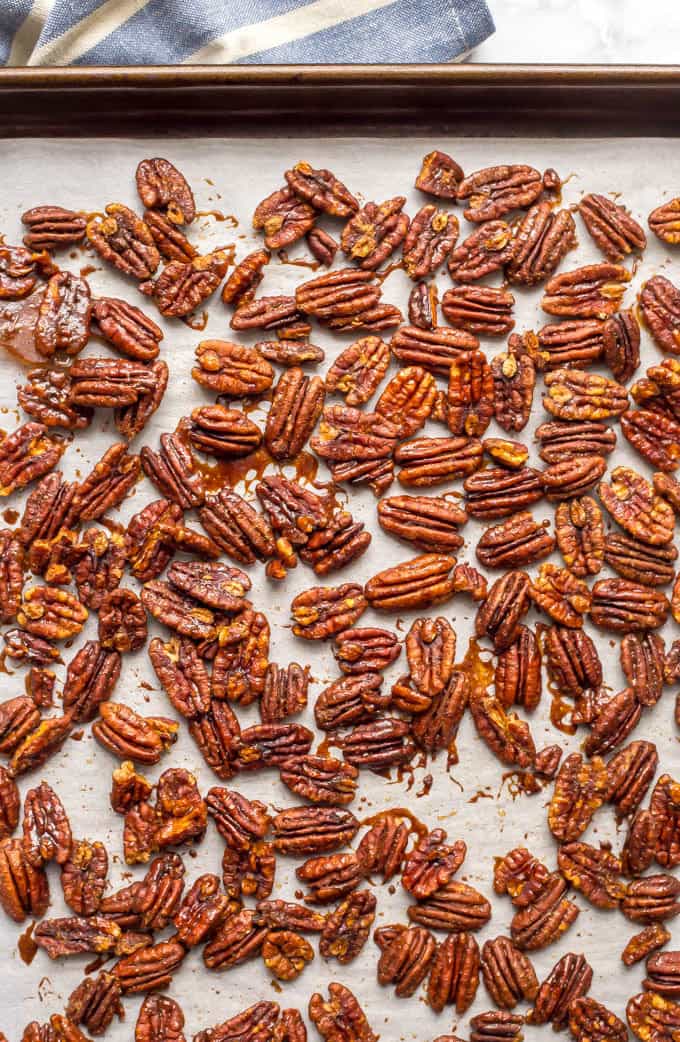 Sweet and spicy pecans with maple syrup are perfectly balanced with salty-sweet flavors and a little heat on the end. They’re a holiday favorite! | www.familyfoodonthetable.com