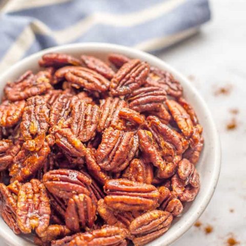 Sweet and spicy pecans with maple syrup are perfectly balanced with salty-sweet flavors and a little heat on the end. They’re a holiday favorite! | www.familyfoodonthetable.com