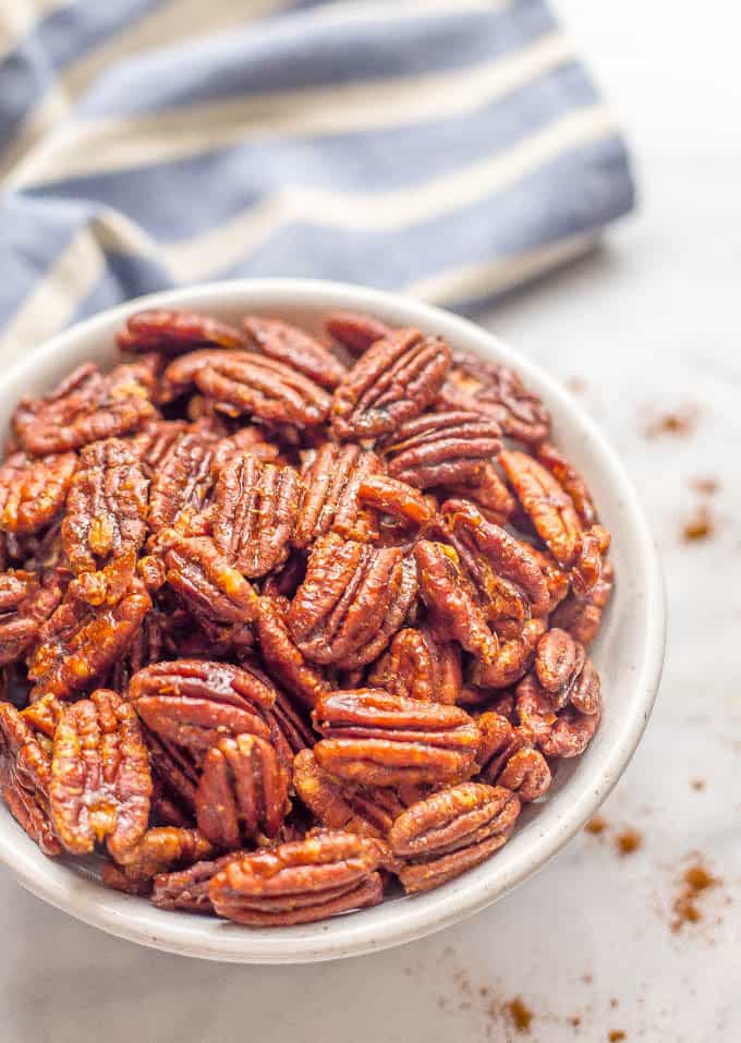 Sweet and spicy pecans with maple syrup are perfectly balanced with salty-sweet flavors and a little heat on the end. They’re a holiday favorite! | www.familyfoodonthetable.com