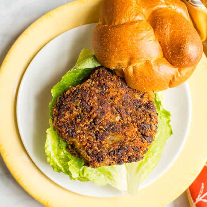 Butternut squash black bean burger on a bun with lettuce underneath