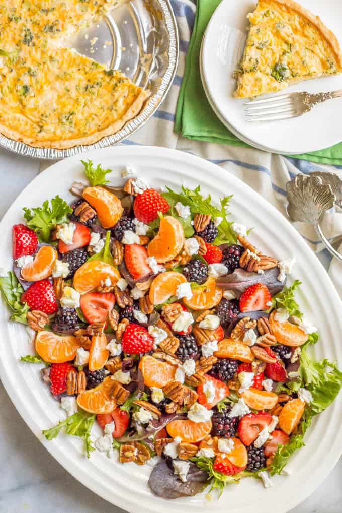This mixed greens salad with fruit, goat cheese and nuts is perfect for a beautiful side dish or brunch spread! It comes together quickly and is finished with a super easy honey-lime vinaigrette. #easysalad #brunch #vegetarian | www.familyfoodonthetable.com