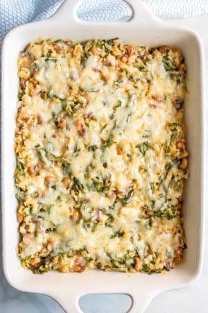 This New Year’s Day black-eyed pea casserole in a large baking dish with cheese melted on top