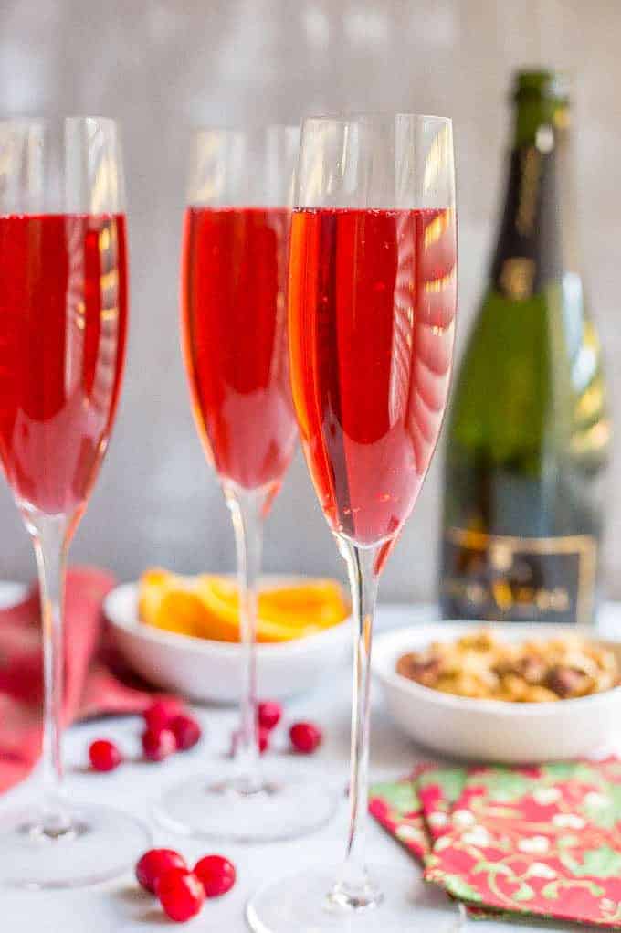 Poinsettia cocktail is an easy but pretty cranberry mimosa that’s fun and festive for the holidays! #champagne #cranberryjuice #mimosa #cocktail #holidays | www.familyfoodonthetable