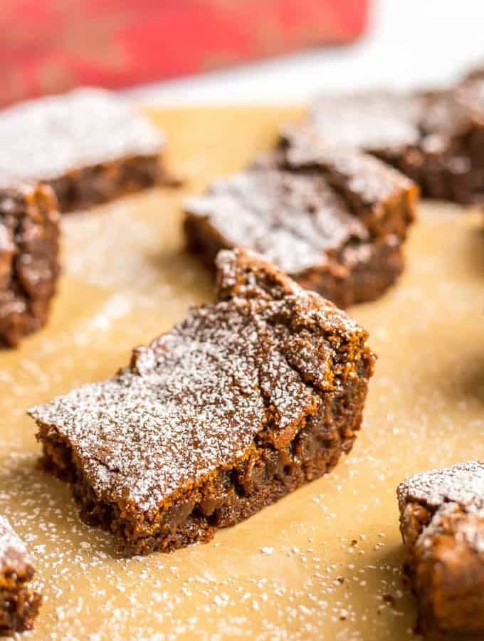 Whole wheat gingerbread cookie bars are soft and chewy and full of warm spices. They are perfect for holiday parties, bake sales and cookie exchanges! #holidaybaking #Christmas #gingerbread | www.familyfoodonthetable.com