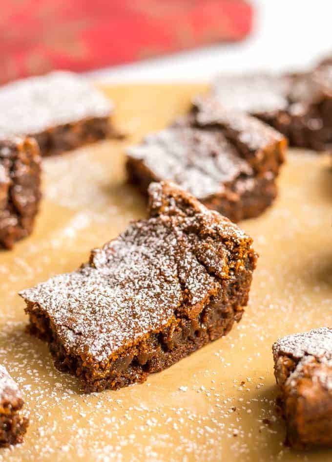 Whole wheat gingerbread cookie bars are soft and chewy and full of warm spices. They are perfect for holiday parties, bake sales and cookie exchanges! #holidaybaking #Christmas #gingerbread | www.familyfoodonthetable.com